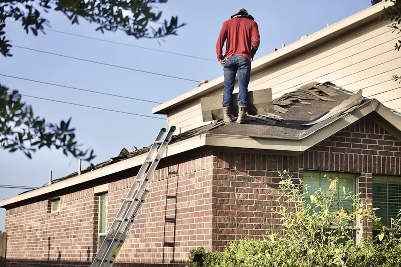 Professional roofer working on a residential roof in Greeley